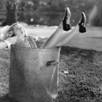 Woman-comedically-toppling-into-a-trash-can